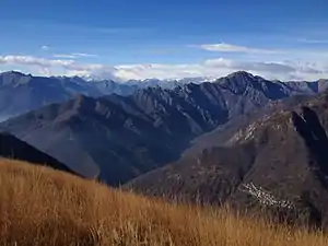 Val Grande, Pizzo Proman (the taller mountain on the right), Cicogna (the small village on the bottom-right corner) and Monte Rosa (left, covered by clouds), seen from Pizzo Pernice