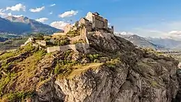 Valère Basilica hill in Sion. Note the prevalence of steppic vegetation in the foreground and vineyards in the background.