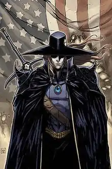 D is shown in his traditional over-cloak and traveler's hat with blond hair, his curved longsword slung over his right shoulder. He stands in front of a tattered American flag.