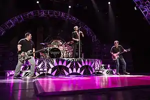 Van Halen performing in 2015. From left to right: Wolfgang Van Halen, Alex Van Halen, David Lee Roth, and Eddie Van Halen.