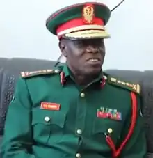 Venance Salvatory Mabeyo in uniform sitting on a couch