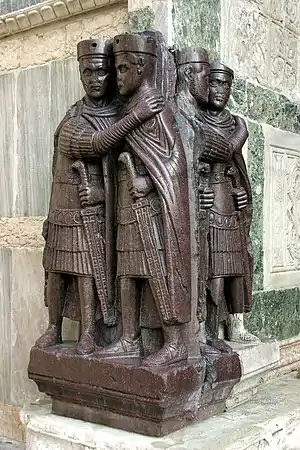 The Tetrarchs, a porphyry statue on Venice's Basilica di San Marco, shows the emperor Diocletian and his three imperial colleagues. All wear the woollen "Pannonian" pileus caps worn by officers in the late army.