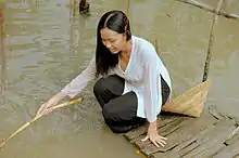 A woman from Southern Vietnam wearing an áo bà ba, a two piece dress worn in the south