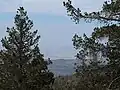 The Mojave Desert is in the distance looking north-east from the summit