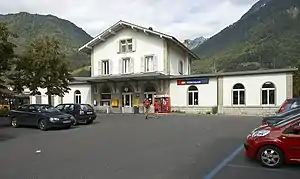 Three-story building with gabled roof and multiple wings