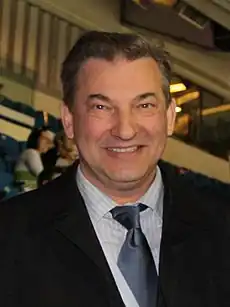 Shoulder high portrait of smiling man wearing a suit and tie