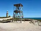 An old WWII radar tower with the Vlamingh Head Lighthouse behind