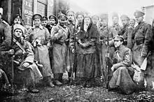 Volunteer Army soldiers and officers next to a train in January 1918