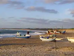 View of beach with small trawlers berthing in Vorupør