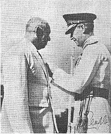 Mr. W. E. Perera receiving his insignia of the order of the M.B.E. from General Sir Gerald Templer, the High Commissioner of the Federation of Malaya.