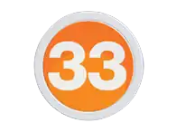 A silver 33 in a sans serif on an orange circle trimmed in silver