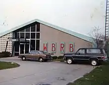 An image of a 1950s-style one-story building with large WBRB lettering and a smaller "1430" below.