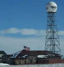 A one-story stone-clad building and a tower with a large radome on top, both emblazoned with the WFRV-TV logo.