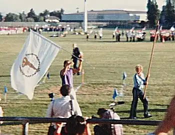 Arnold Schwarzenegger, winner of seven consecutive world championships, carries the flag of the International Federation of Bodybuilders in the opening ceremony of World Games I in 1981 at Santa Clara University, California.