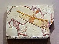 Egyptian boat-building relief, featuring a workman using an adze