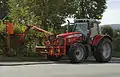 A tractor-mounted hedge trimmer ("hedge cutter")