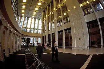 Wide angle view of the mirror and marble-clad elevator core inside the South Tower lobby. The ceiling height is 22 m (72 ft).