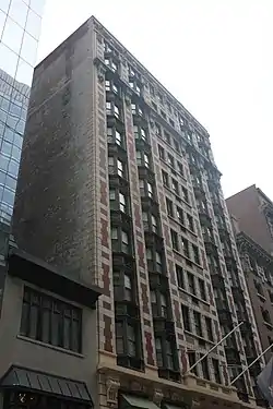 The hotel's main facade, made of brick and stone, as seen from the street