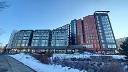 WaHu Student Apartments on a clear day with snow on the ground. The left side is lower, six stories; the right side is eleven.