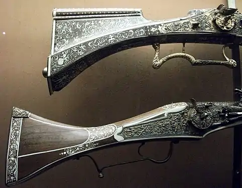 Inlaid stocks of two German guns