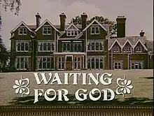 Front view of large English manor home with large lawn, with text "Waiting for God" superimposed