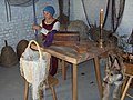 Woman in common fifteenth century dress repairing fishing net