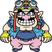 An overweight character with pointy ears, a pink nose, thick eyebrows, muscular arms and a wavy moustache. He wears a navy blue shirt with a light blue jacket, pink pants with a red belt, blue shoes, and yellow biker gloves with a blue W. On his head, a yellow biker helmet with a blue W, goggles, and a red strap.