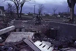 An empty foundation with bare trees and overcast skies in the background