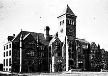 Early 20th-century black-and-white photo of three-story building