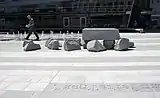 granite slabs lying on the ground that appear to disintegrate back into their rock formations as they get further from the camera's eye