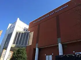 Photo of a red-brick building with the words "Weatherspoon Art Museum" spelled out near the rooftop.