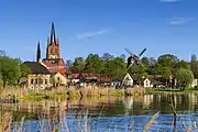 The Holy Spirit Church and "Goat's windmill" on the shore of the Havel