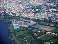 Aerial view of the stadium's old configuration with curved ends and red seats (2005)