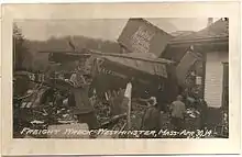 A derailed freight train with broken and mangled boxcars