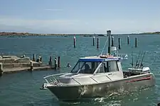 Whanganui River mouth, boat and swimmers