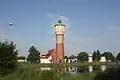 Water tower with surroundings and pond