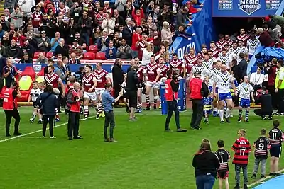 Warrington and the Wigan Warriors walking out ahead of the match at Anfield in 2019