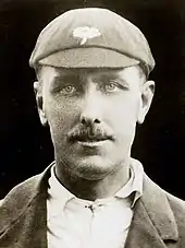 A close up of a man in an MCC cap