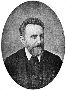 Black-and-white portrait photograph of a bearded gentleman