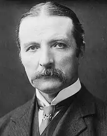 Victorian photograph of man in early middle age, with centre-parted hair and a walrus moustache