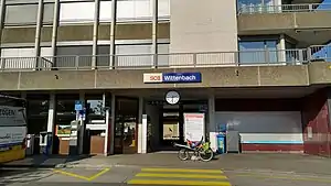 Station with flat-roofed one story entrance and office space above