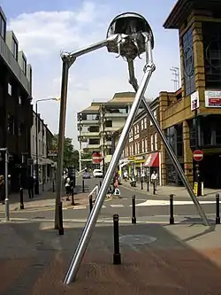 Image 21Statue of a tripod from The War of the Worlds in Woking, England, the hometown of author H. G. Wells. The book is a seminal depiction of a conflict between mankind and an extraterrestrial race. (from Culture of the United Kingdom)