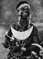 A Solomon Islands woman wearing a shell pectoral resembling a reimiro.