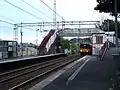 Gourock bound train enters from the east. The ticket office, to the right of the train, is now used at peak times only.