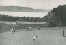 Golfers on a large riverside course