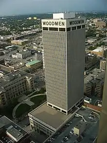 Arial view of the WoodmenLife Tower (center). Image features a 30 story skyscraper with its associated parking garage.