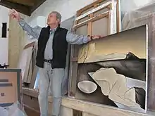 Yatrides surrounded by his paintings