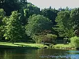 View of west end of the park where a small bridge goes over the Yantacaw Brook before flowing into the pond