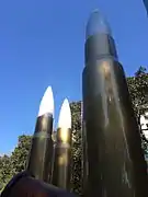 Three of the artwork's four standing bullets