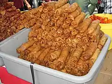 Hot and spicy fried popiah, popular in Malaysia. On the left side of the photo, the popiah is coated with heavy chili sauce.